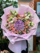 Bouquet con ortensia viola, eustoma, alstroemeria, rose rosa e pesco